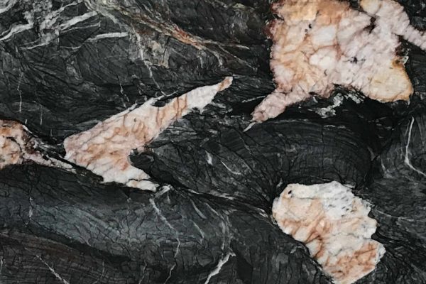 Crytos Quartzite countertop featuring deep black, grey, and rose-gold accents
