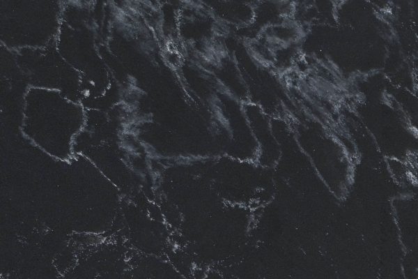Midnight Corvo Concrete Quartz countertop featuring charcoal tones with subtle grey veining and concrete-inspired finish