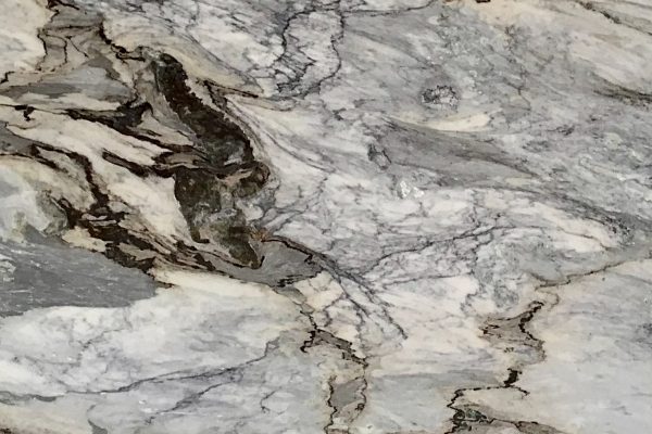 Portinari Marble countertop featuring bold patterns in grey, white, and golden brown tones