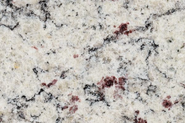 SF Real Granite countertop displaying bright white background with distinctive burgundy and charcoal veining patterns