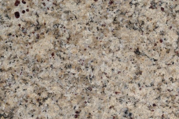 Santana Granite countertop featuring warm beige tones with black and rust-colored mineral inclusions