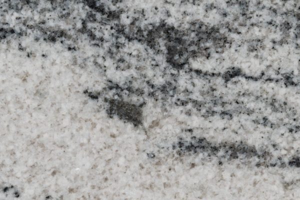 Silver Cloud Granite countertop showcasing luminous white background with flowing gray veining patterns