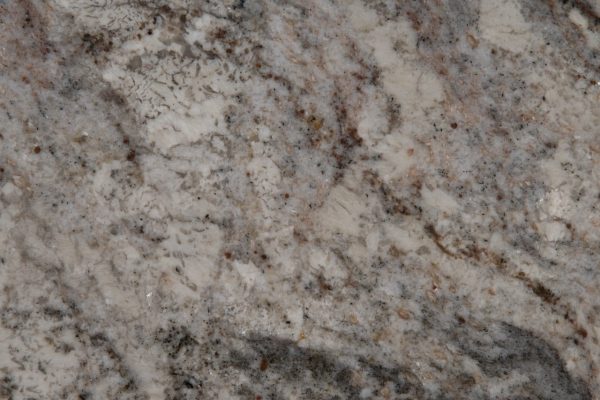 White Spring Granite countertop featuring creamy whites, warm beige, and dramatic grey and burgundy veins
